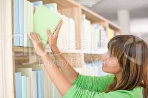 Student in library - happy woman choose book