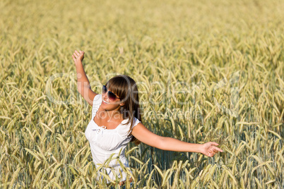 Happy young woman in corn field enjoy sunset