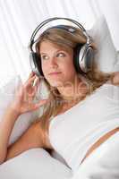 White lounge - Young smiling woman listening to music