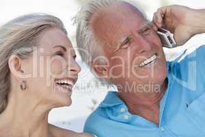 Happy Senior Couple Talking on Mobile Cell Phone