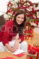 Attractive brunette writing Christmas cards