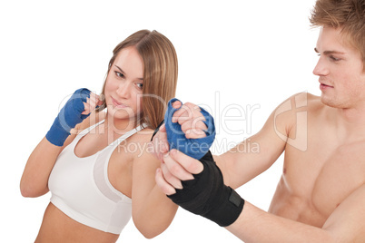 Boxing - Young woman in class training on white