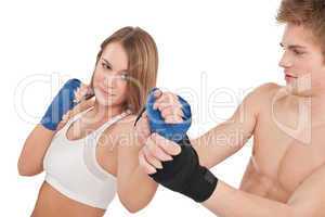 Boxing - Young woman in class training on white