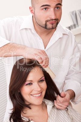 Professional hairdresser comb customer at salon