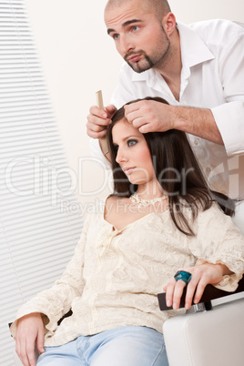 Professional hairdresser comb female customer at salon