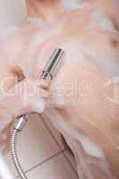 Body care: Woman holding shower head