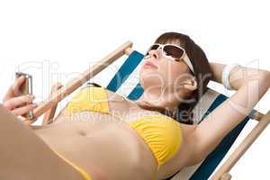 Beach - Woman listen to music in bikini sunbathing