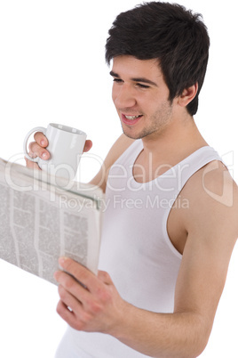Morning - young man with coffee and newspaper