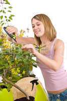 Gardening - Happy woman cutting Rhododendron flower