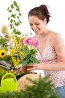 Gardening - woman holding flower pot and shovel