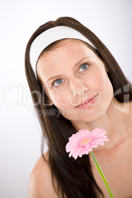 Beautiful woman holding gerbera daisy flower