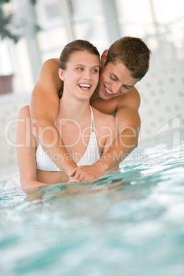 Young sportive couple have fun in swimming pool