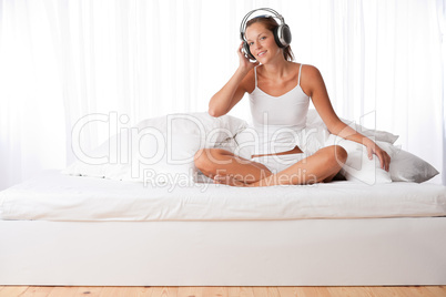 Young woman in white with headphones