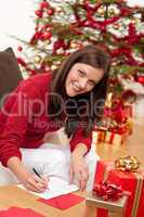 Attractive brunette writing Christmas cards