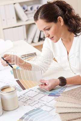 Young female interior designer working at office