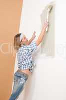 Home improvement: Woman painting wall