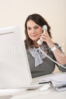 Attractive executive woman on phone at office