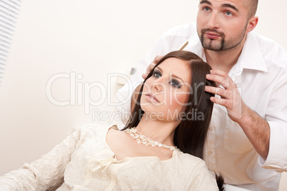 Professional hairdresser comb female customer at salon