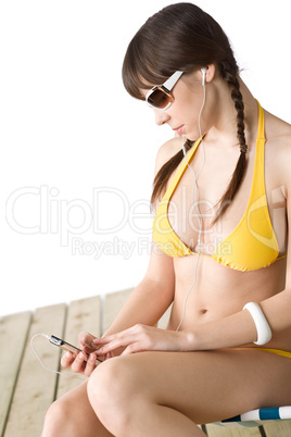 Beach - Woman listen to music in bikini sunbathing