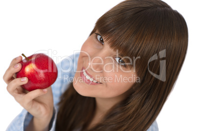 Happy teenager eating healthy apple for breakfast