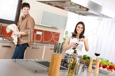 Happy couple cook in modern kitchen
