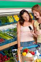 Grocery store shopping - Two women with mobile phone