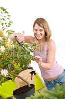 Gardening - Happy woman cutting Rhododendron flower