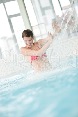 Swimming pool - happy woman under water stream