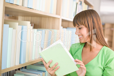 Student in library - happy woman read book