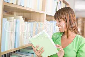 Student in library - happy woman read book