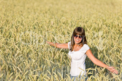 Happy woman in corn field enjoy sunset