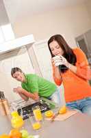 Young couple drinking coffee in the kitchen