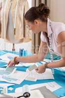 Professional tailor working with fashion sketches