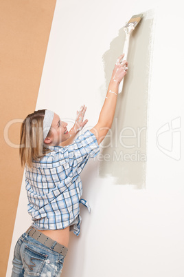 Home improvement: Woman painting wall