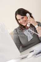 Attractive executive woman on phone at office