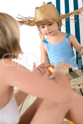 Beach - Mother with child apply suntan lotion