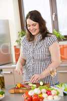 Cook - plus size woman cutting salami and vegetable