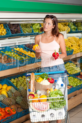 Grocery store shopping - Young woman choosing pepper