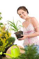 Gardening - woman holding flower pot, watering can