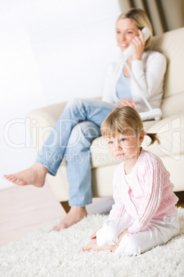 Mother and child in living room watch television