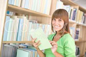 Student in library - cheerful woman choose book