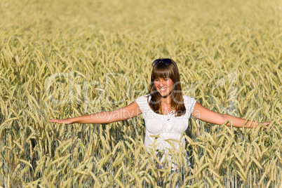 Happy young woman in corn field