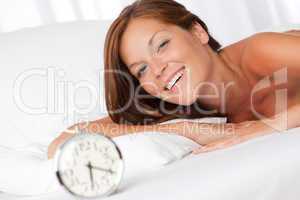 White lounge - Smiling woman with alarm clock