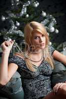 Provocative woman posing in front of Christmas tree