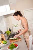 Young smiling woman in the kitchen