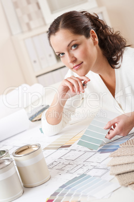 Young female interior designer working at office