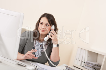 Young woman talking on the phone at office