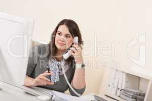 Young woman talking on the phone at office