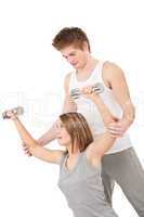 Fitness - Young woman with instructor lifting weights