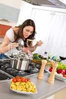 Cooking - young woman in modern kitchen